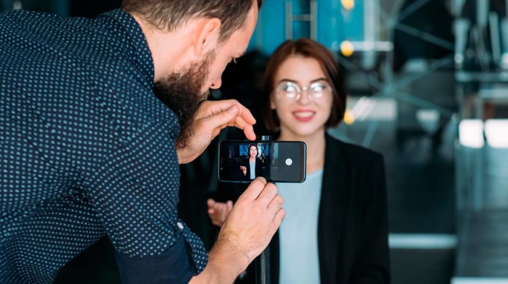 woman being recorded by a man