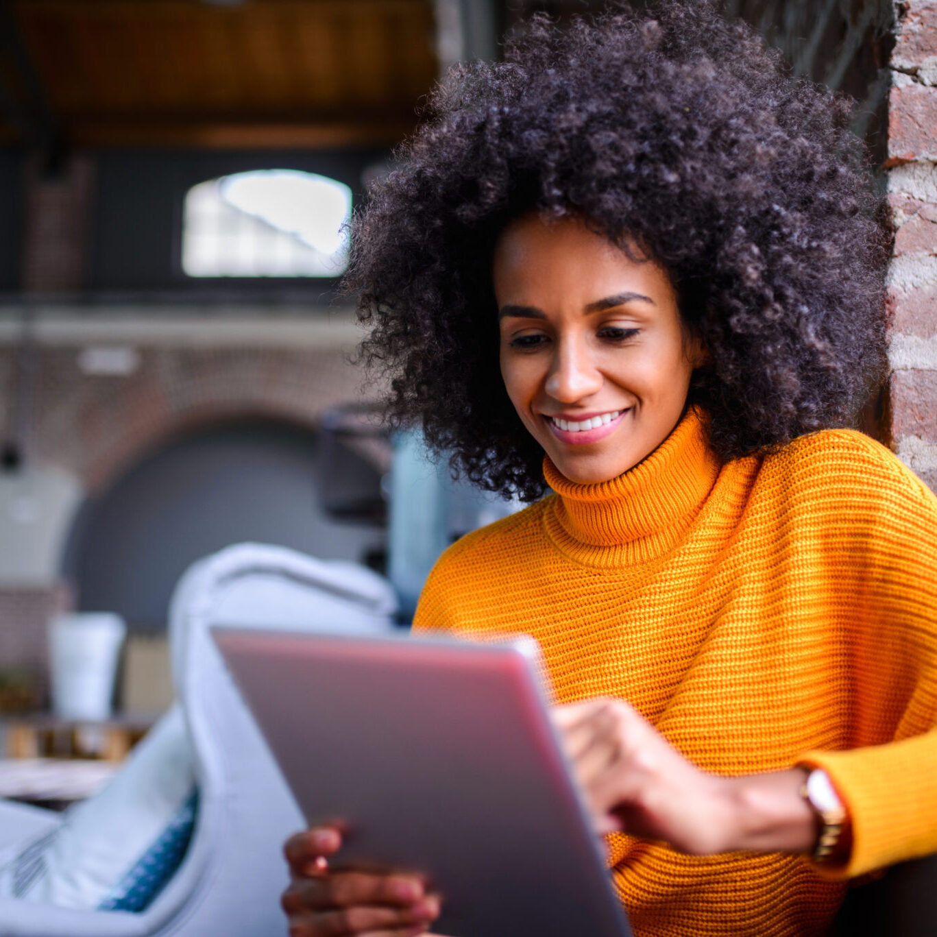 Smiling African American woman using digital tablet.